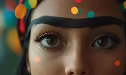 a woman with long eyelashes looking at the camera