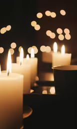 white candles with different lit candle types around them