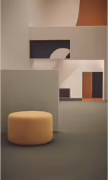 an up close picture of a beige ottoman in a room