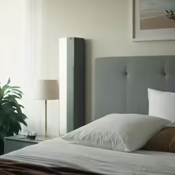 a bedroom with a bed and window in the background