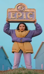 a woman with her hands on the back of her head