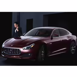 a woman in a black suit stands next to a red car