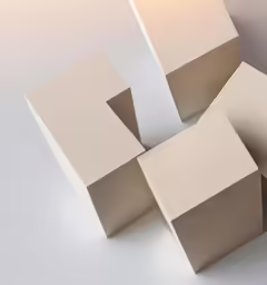 three blocks of paper with an individual on top