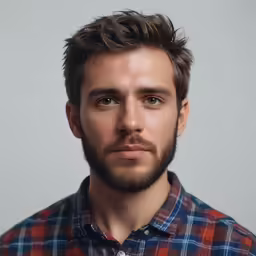a man with a goatee is posing for a photo