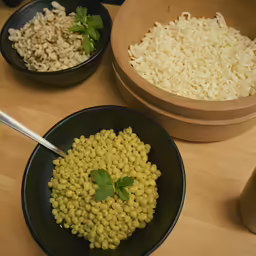 three bowls that have food in them on top of a table