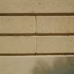 a close up shot of a cement block with a cat sitting on top