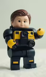 an action toy boy holding up his camera