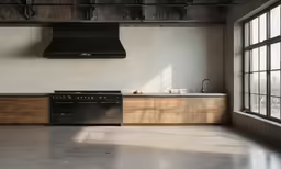 an industrial kitchen with large windows and an oven