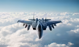 a jet flies through the air over white clouds