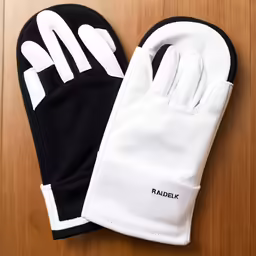 a pair of gloves that reads radbiki sitting on top of a wooden table