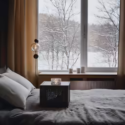 a bedroom with a window, a bed and a night stand