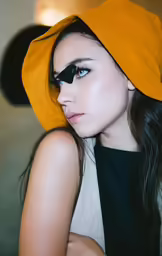 a woman wearing a black mask with black eyeliners