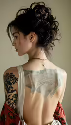 a woman has an unusual piece of ink on her back