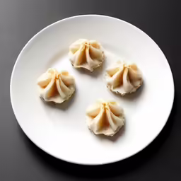 five pieces of food sitting on top of a white plate