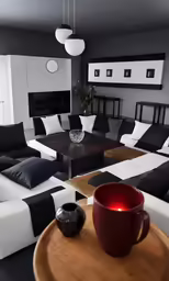 a living room with couches, a table and a potted plant