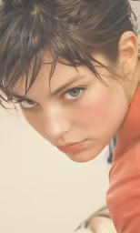 a girl is looking up as she covers her face with her hand
