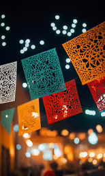 colorful lanterns hanging on strings in front of the lights