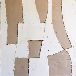 a wall covered with white and brown pieces of paper