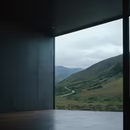 the large windows are opened and showing a valley