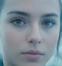 a woman with blue eyes looking at the camera
