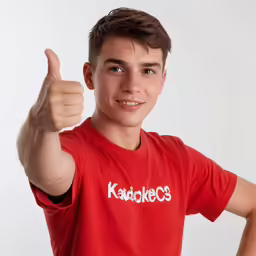 the boy is showing his thumbs up for the camera