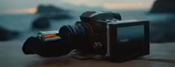 a camera sitting on top of a large rock