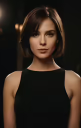a woman in black top with short hair