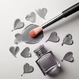 a brush on top of some broken hearts