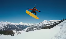 person in midair on snow board high up above