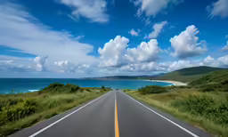 a road leading into the water and blue sky