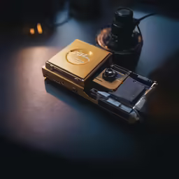 some electronics and a lamp on a table