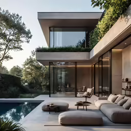an outdoor couch and chair in front of a large building