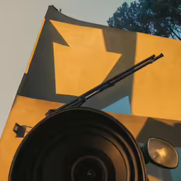 an antenna hanging from a building next to trees