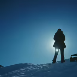 a person standing on the top of a snowy hill