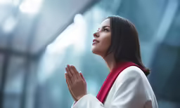 an oriental american woman is in a room praying