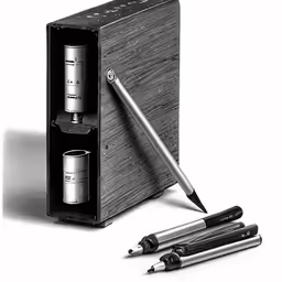 two pens and one empty bottle with a pen in it