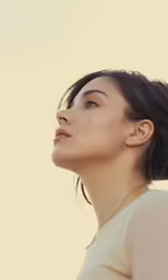 a young woman is looking up into the sky
