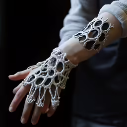 a hand with two hands wearing knitted white hands
