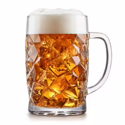 a glass mug filled with liquid on top of a white table