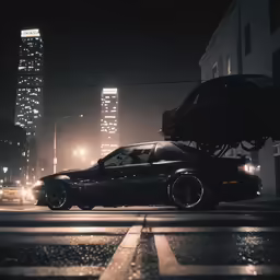 the car is driving in front of a skyscraper at night