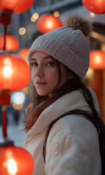 a woman wearing a white jacket, scarf and hat