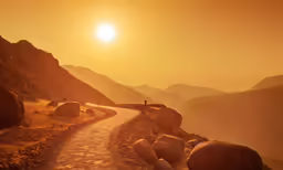 a person stands on a hill with large rocks