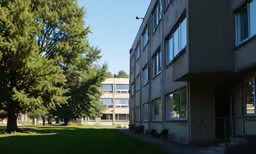 a building that is on a street with green grass