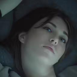 a woman is laying in bed with a blanket