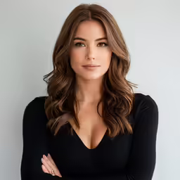 a woman standing with her arms folded
