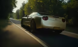 car driving down an winding country road with trees and trees in the background