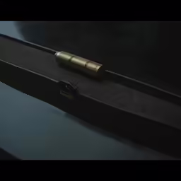 a gun on display with a lighted light coming from the front