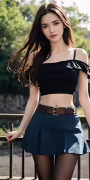 a girl wearing black clothes standing by a fence
