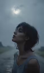 a woman looking into the sky on a rainy day
