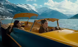 people inside a yellow and blue speedboat in a body of water